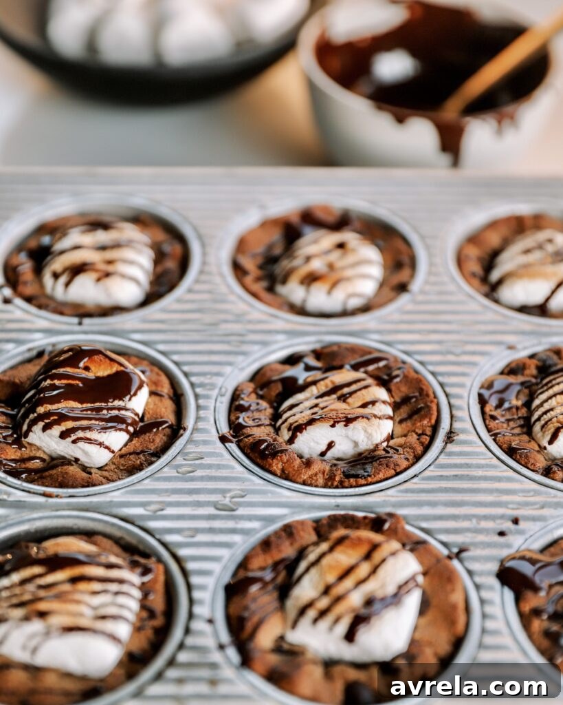 A finished S'mores Cookie Cup with melted marshmallow and chocolate drizzle.