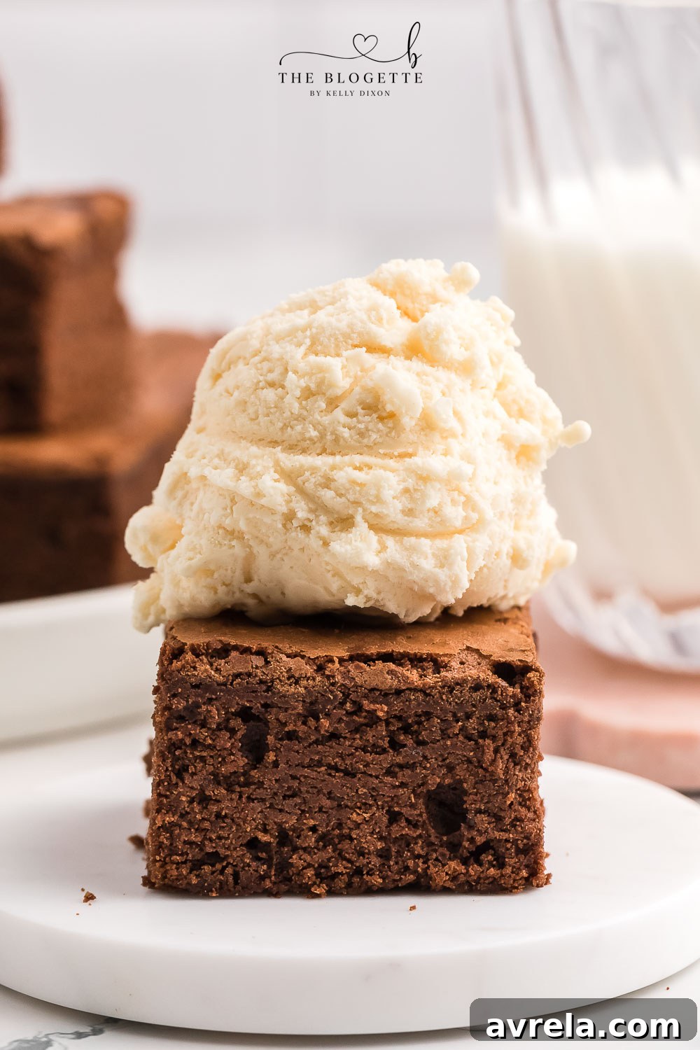 Warm brownies served with a scoop of vanilla ice cream and chocolate drizzle.