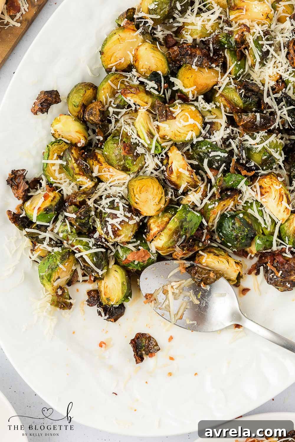 Honey Bacon Brussels Sprouts topped with a generous sprinkle of grated Parmesan cheese.