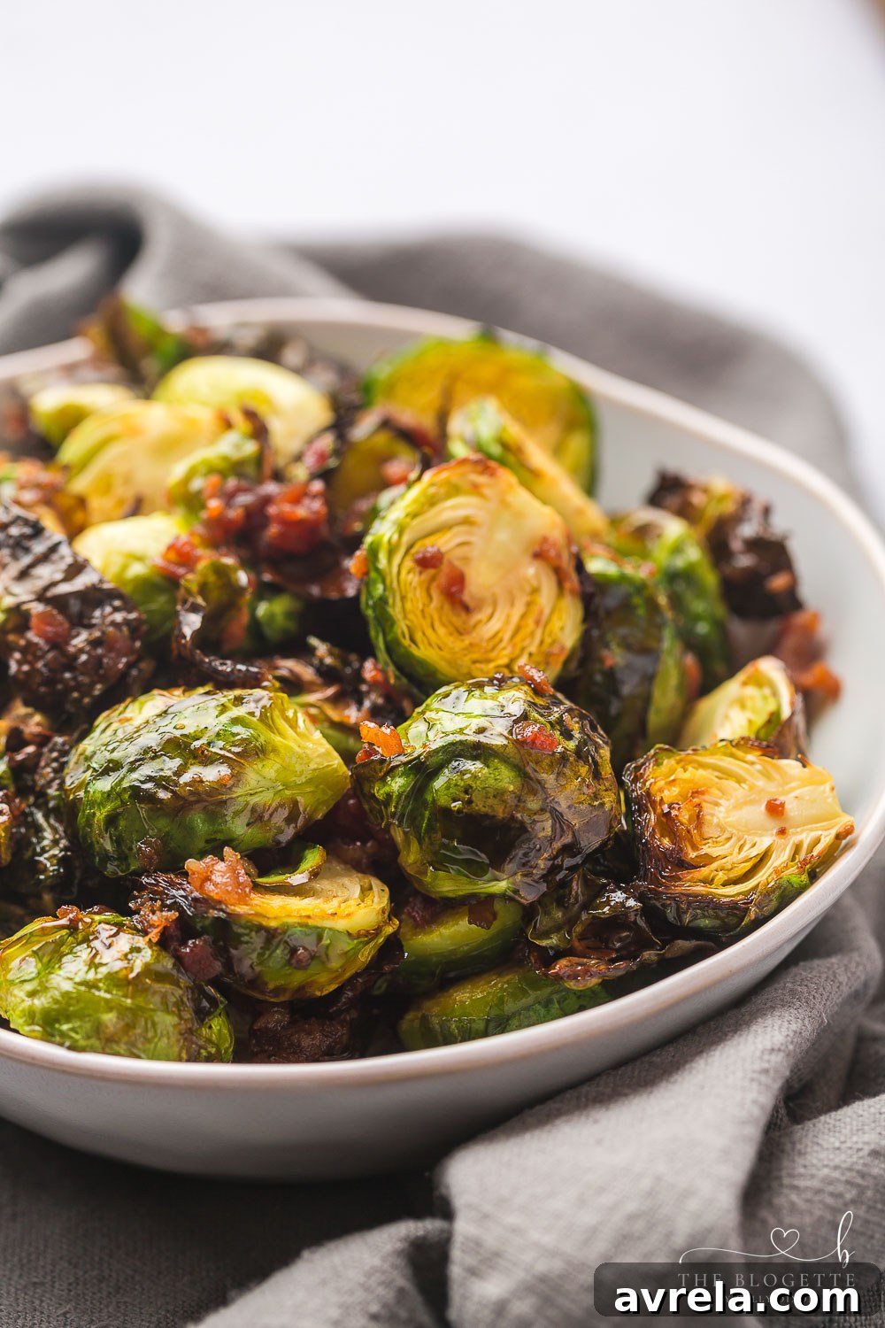 Honey Bacon Brussels Sprouts garnished with fresh parsley, ready to be enjoyed.