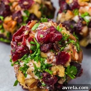 Cranberry Pecan Goat Cheese Balls are festive mini cheese truffles loaded with creamy goat cheese, sweet cranberries, and crunchy pecans!