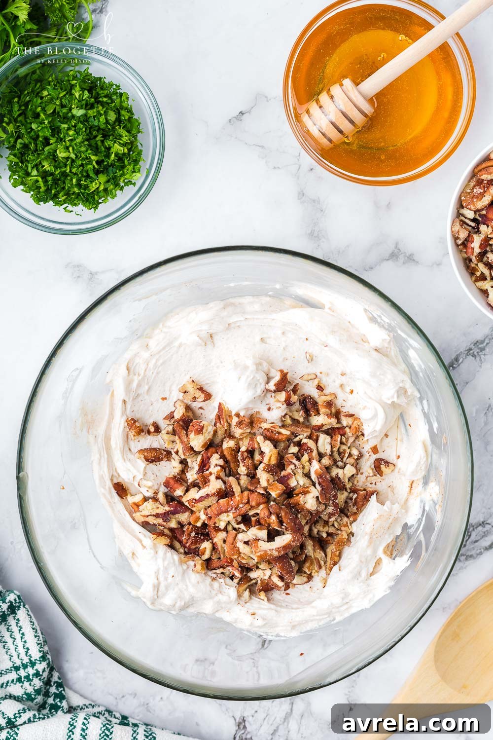 A smooth, creamy goat cheese mixture in a glass mixing bowl, ready for shaping into truffles.