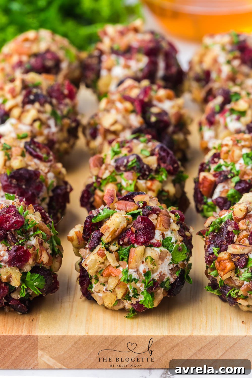 A stunning platter of Cranberry Pecan Goat Cheese Balls, artfully arranged and garnished for a festive presentation.
