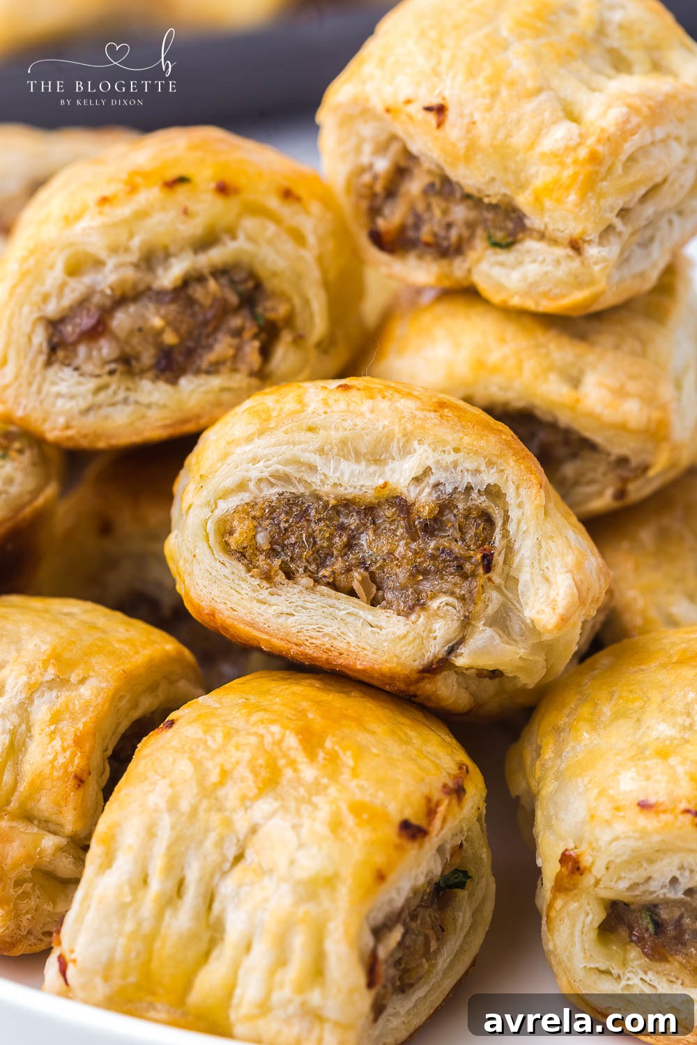 Golden brown sausage rolls, freshly baked and ready to serve, a perfect appetizer.