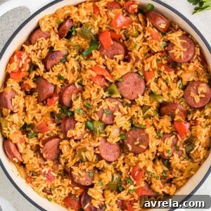 This Sausage and Rice Skillet features smoky sausage sizzled with sweet bell pepper, onions, and garlic in vibrant tomato sauce.