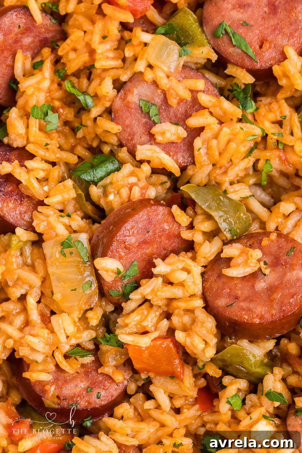 This Sausage and Rice Skillet features smoky sausage sizzled with sweet bell pepper, onions, and garlic in vibrant tomato sauce. A family-friendly recipe.