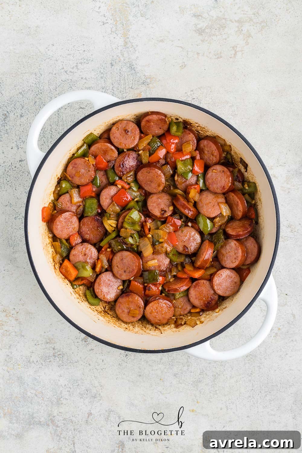 Garlic, paprika, salt, and pepper stirred into the sausage and peppers mixture.