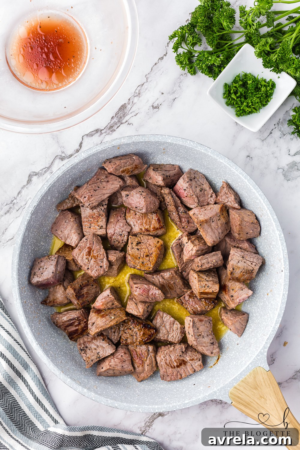 Cooking steak cubes in melted butter and garlic