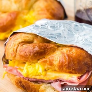 Croissant Breakfast Sandwiches are the ultimate breakfast comfort! Buttery flakey bread stuffed with eggs, ham, and melted cheese.