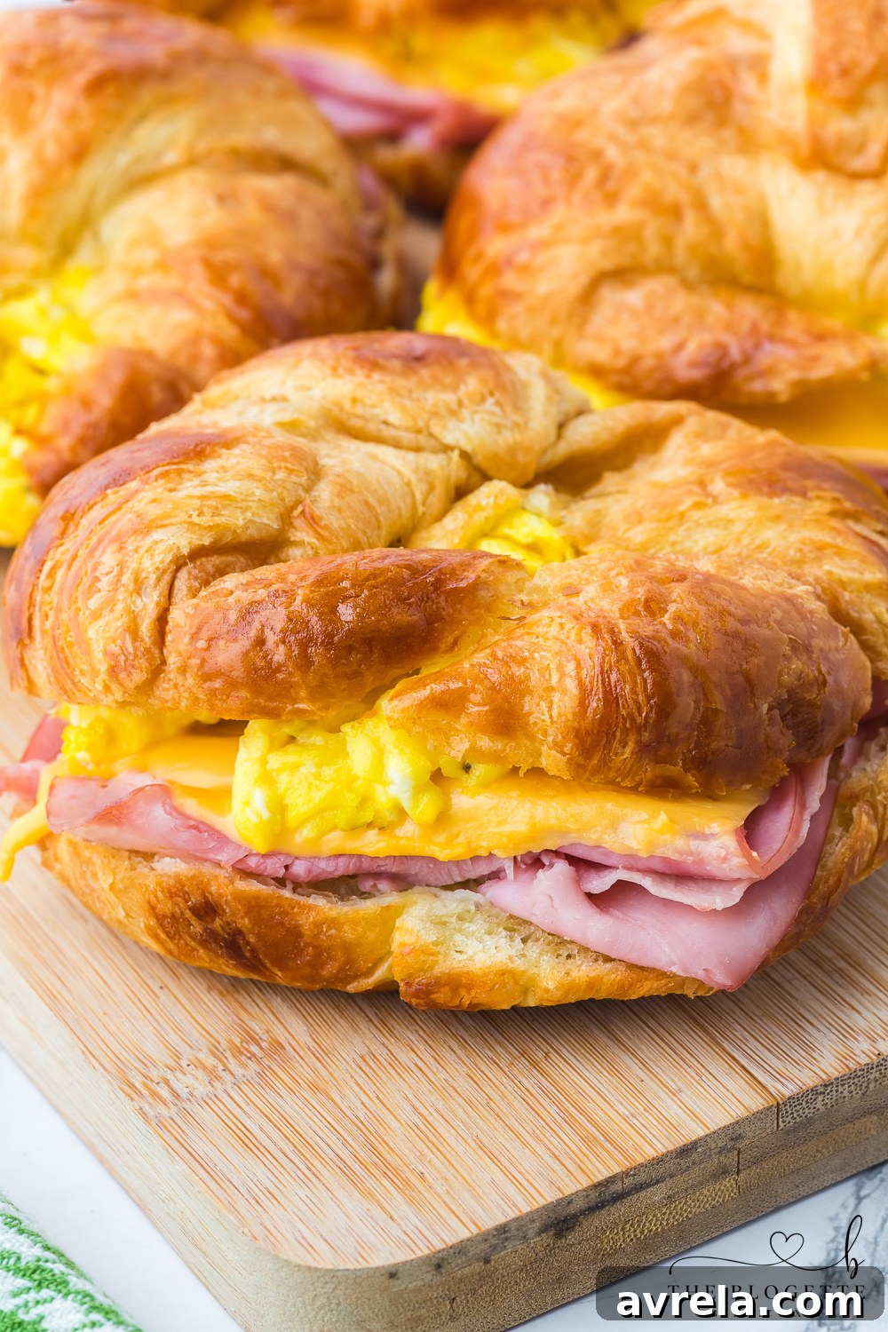 Golden Croissant Breakfast Sandwiches 3 Croissant Breakfast Sandwiches are the ultimate breakfast comfort! Buttery flakey bread stuffed with eggs, ham, and melted cheese.