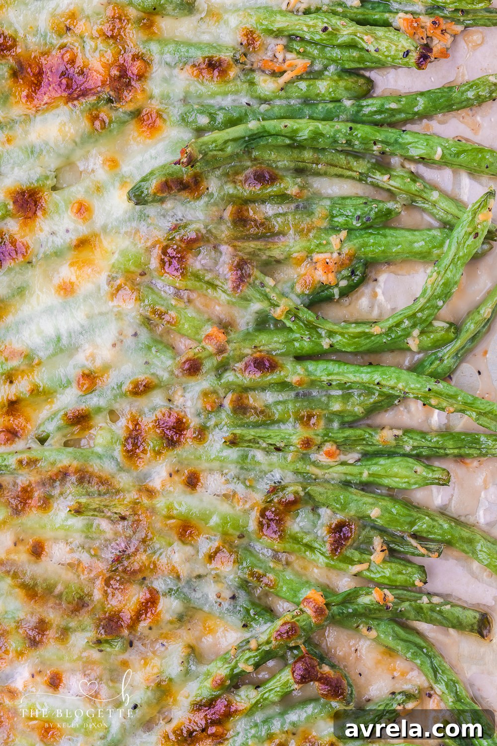A vibrant platter of golden-brown cheesy garlic baked green beans, topped with fresh herbs, showcasing their irresistible texture and rich flavors, ideal for any meal.