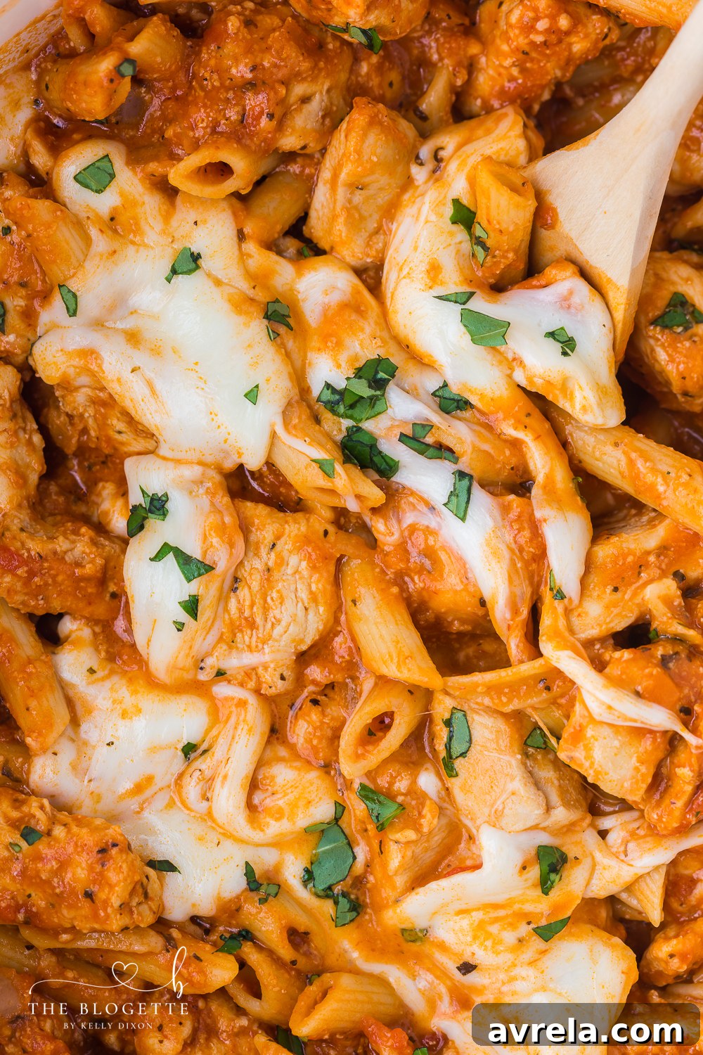 Creamy Chicken Parmesan Pasta 10 A large serving of one-pot Chicken Parmesan Pasta in a bowl, garnished with fresh basil.