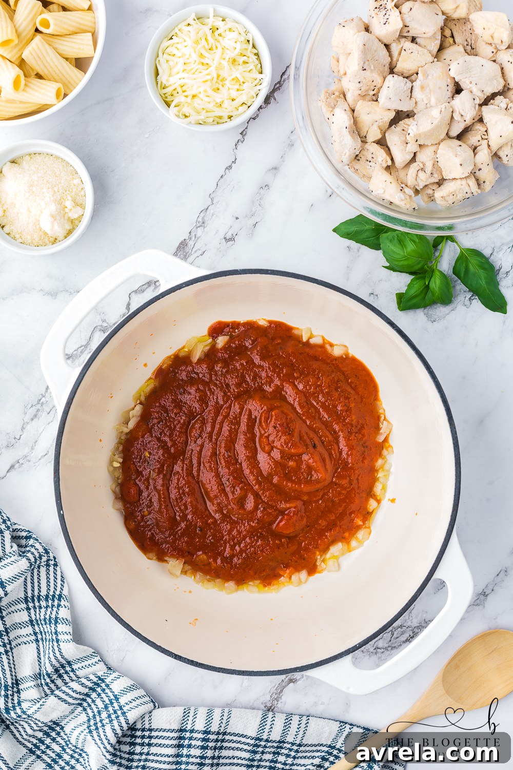 Creamy Chicken Parmesan Pasta 7 Sweet onion and marinara sauce simmering together in a large Dutch oven.