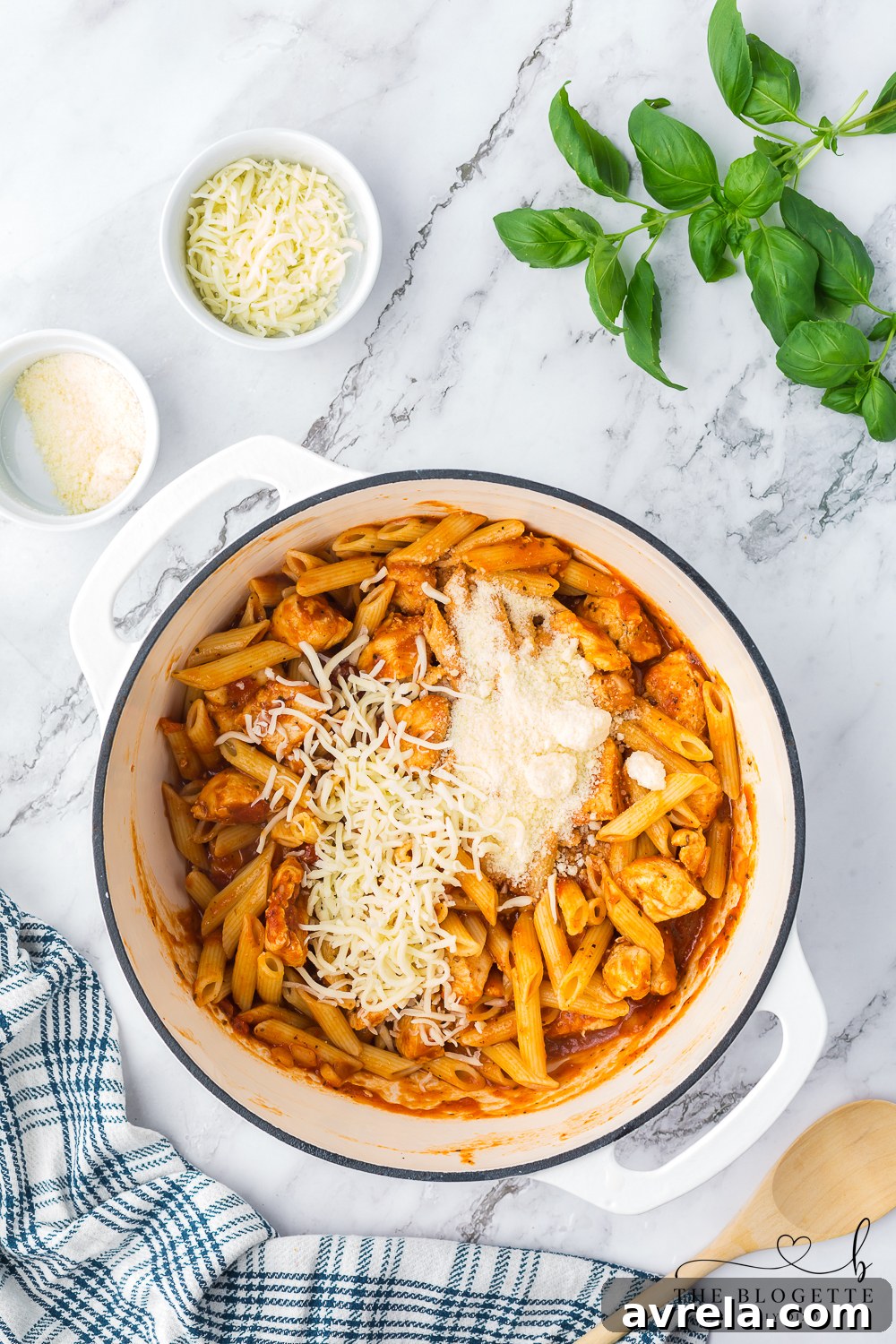 Creamy Chicken Parmesan Pasta 9 Close-up of molten mozzarella and parmesan cheese covering Chicken Parmesan Pasta in a pot.