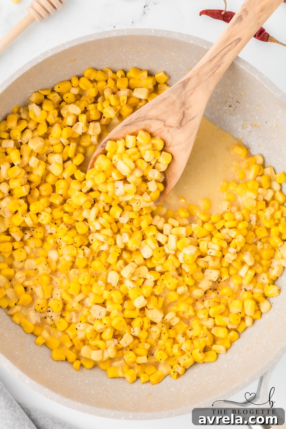 Close-up of creamy Honey Butter Skillet Corn in a cast iron pan.