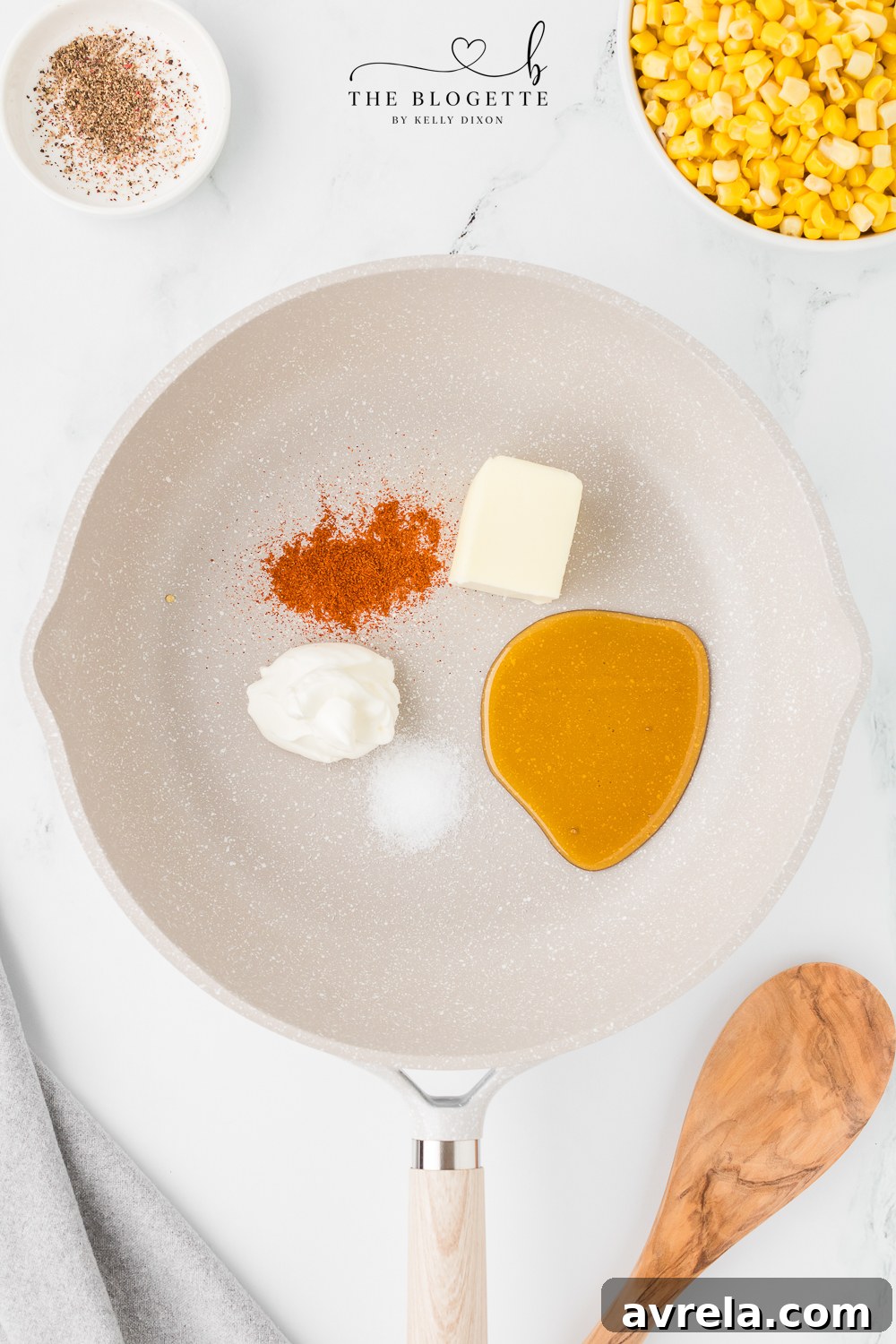Essential ingredients for Honey Butter Skillet Corn laid out on a wooden board.