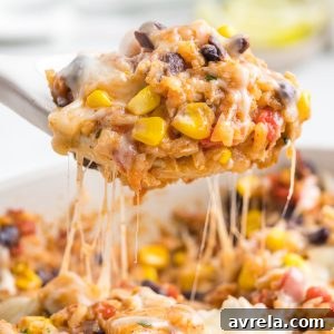 One-pan Tex Mex Chicken and Rice packed with chicken, rice, tomatoes, beans, corn, chilies, and ooey gooey melted cheese!