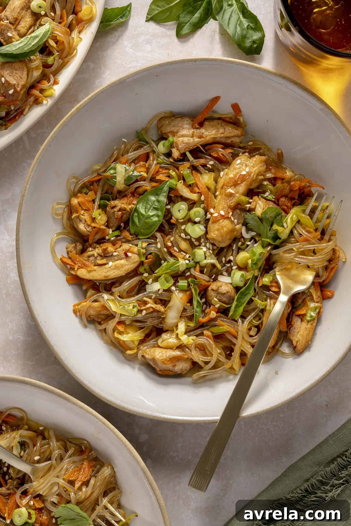 Sticky Honey Garlic Chicken Noodles 2 Gluten-free honey garlic chicken stir fry with sweet potato glass noodles served in a bowl.