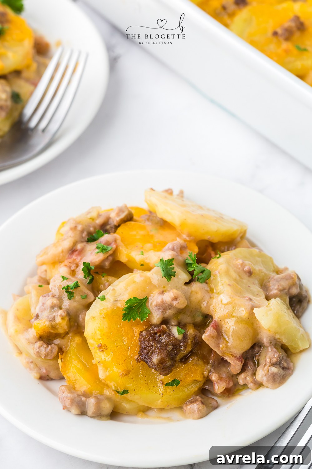 Hearty Beef and Potato Bake 11 A large serving of Hamburger Potato Casserole on a plate, showing the layers of beef, potatoes, and cheese.