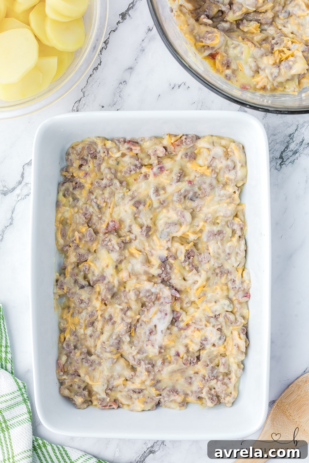 Hearty Beef and Potato Bake 8 The creamy meat mixture, with cheese and bacon, expertly combined in a large bowl, ready for casserole assembly.