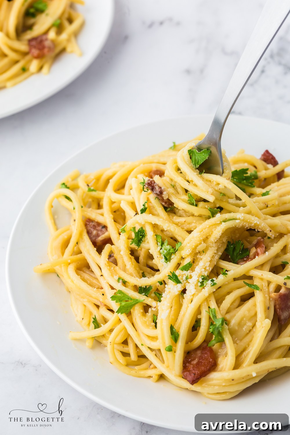 A close-up shot of a steaming bowl of 30-minute Spaghetti Carbonara, showing the creamy sauce coating the spaghetti, mixed with crispy bacon, and ready to be served. This easy and comforting Italian pasta dish is perfect for quick dinners.