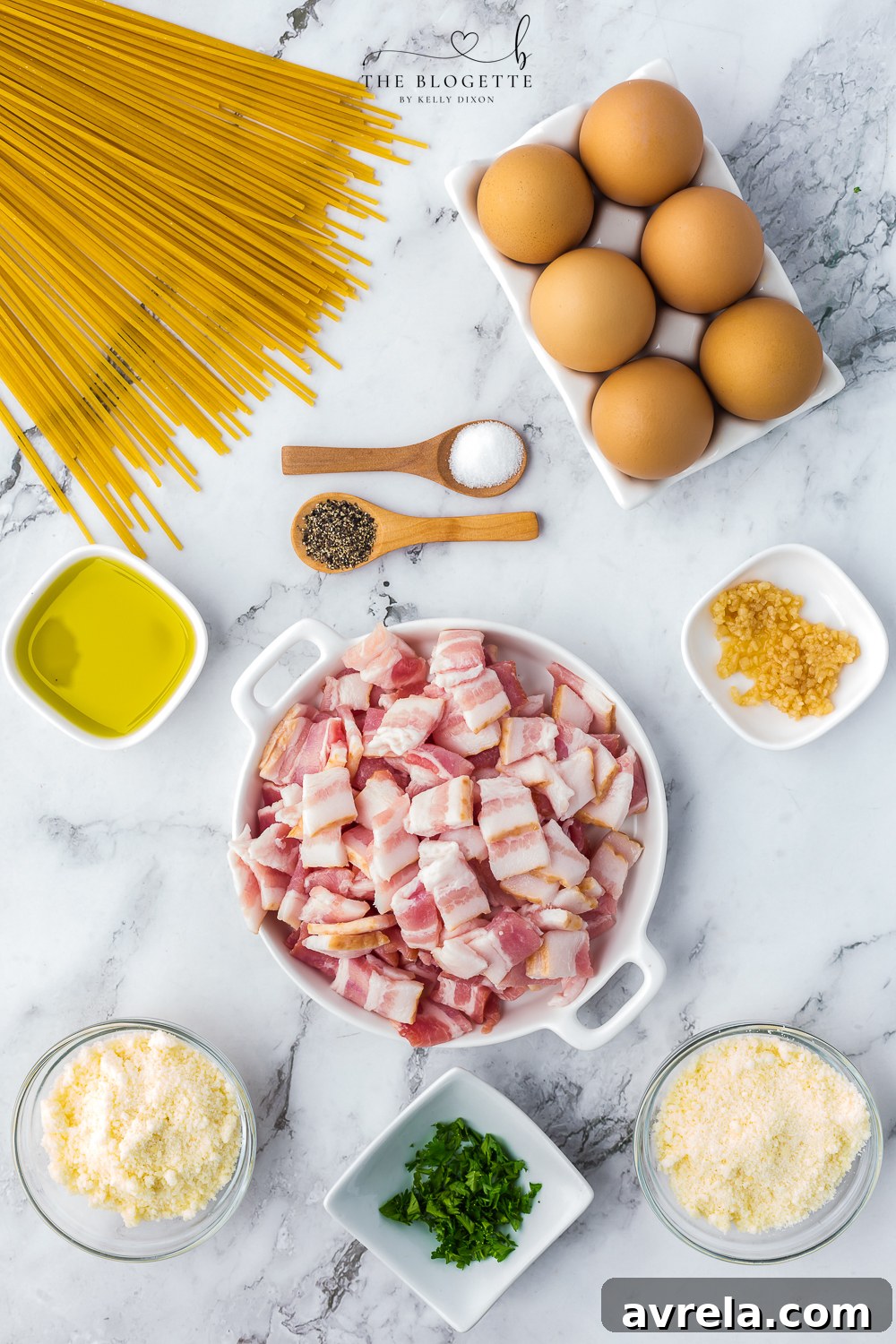 All the fresh ingredients laid out for making Spaghetti Carbonara, including spaghetti, eggs, bacon, parmesan and pecorino romano cheese, garlic, and fresh parsley, highlighting the simplicity of this classic Italian recipe.