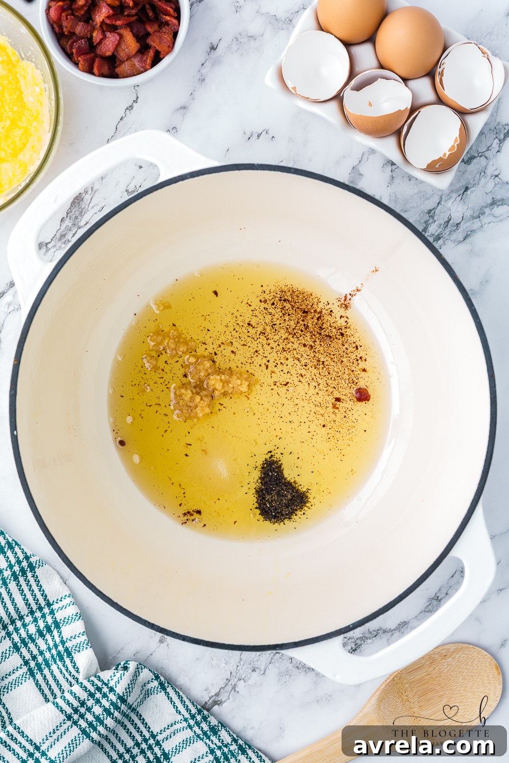 The process of deglazing a skillet with pasta water after cooking bacon and garlic, creating a flavorful base for the Carbonara sauce by incorporating all the rich brown bits from the pan.