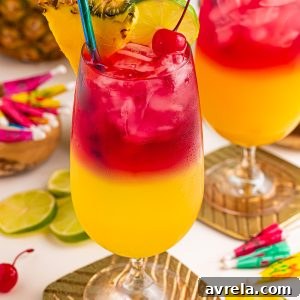 Make a beautiful Malibu Bay Breeze cocktail by layering pineapple juice, Malibu rum, and cranberry juice! Perfect all spring and summer long!