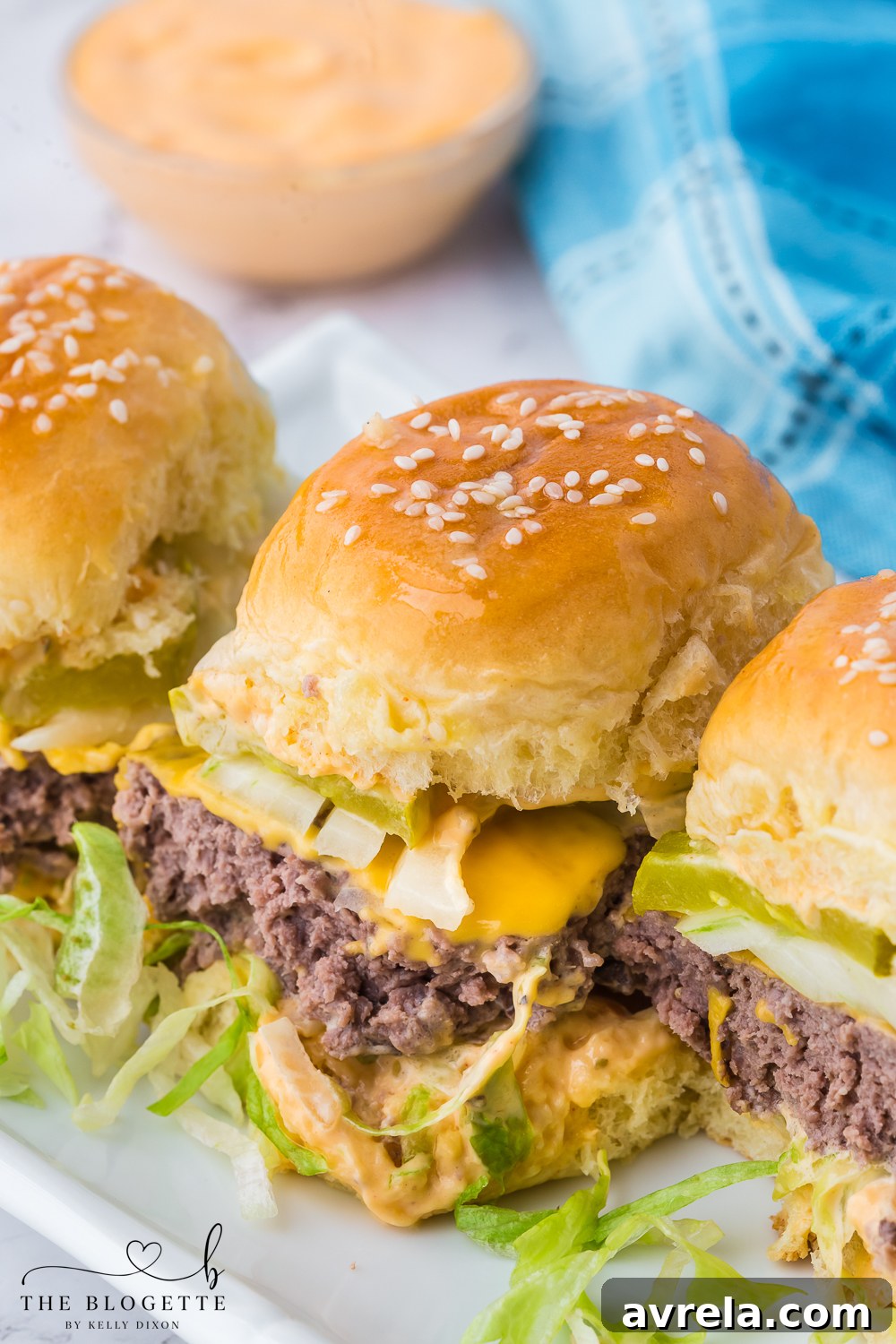 Mini Big Mac Bites 2 Delicious Big Mac Sliders, mini burgers with special sauce, lettuce, cheese, and pickles on buttery buns.