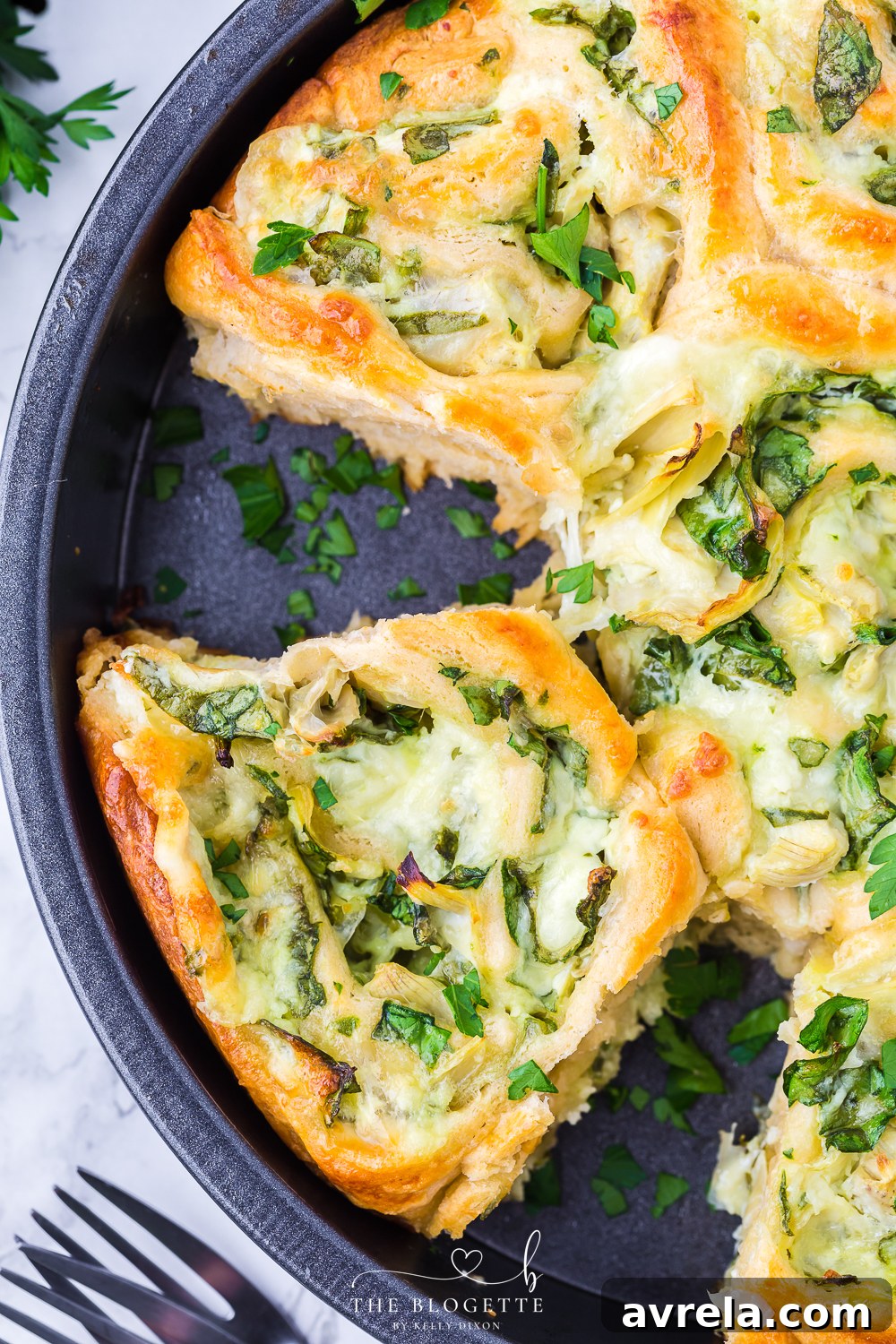 Golden brown Cheesy Spinach Artichoke Pinwheels arranged perfectly in a pie plate, a wonderful appetizer for any event.
