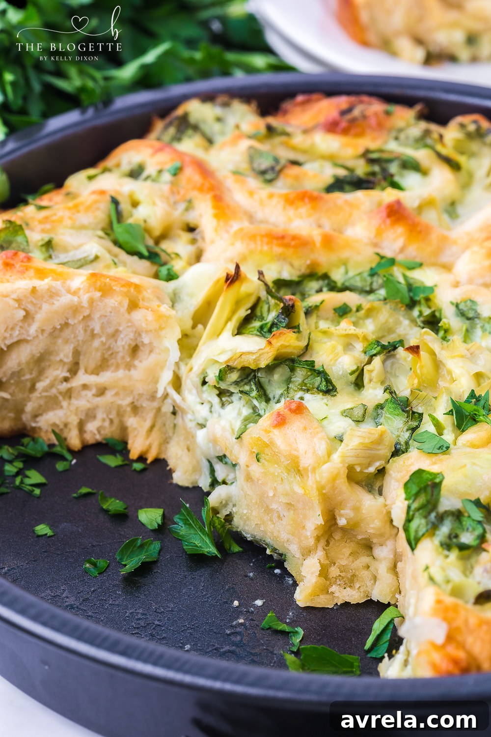 Multiple plates of Cheesy Spinach Artichoke Pinwheels, emphasizing their appeal as a delicious, shareable party food.
