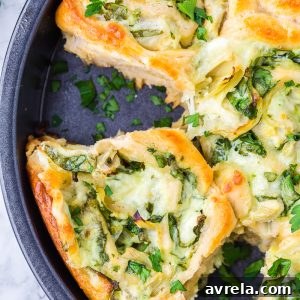 Cheesy Spinach Artichoke Pinwheels, a perfect pastry-stuffed roll appetizer for game day or any event.