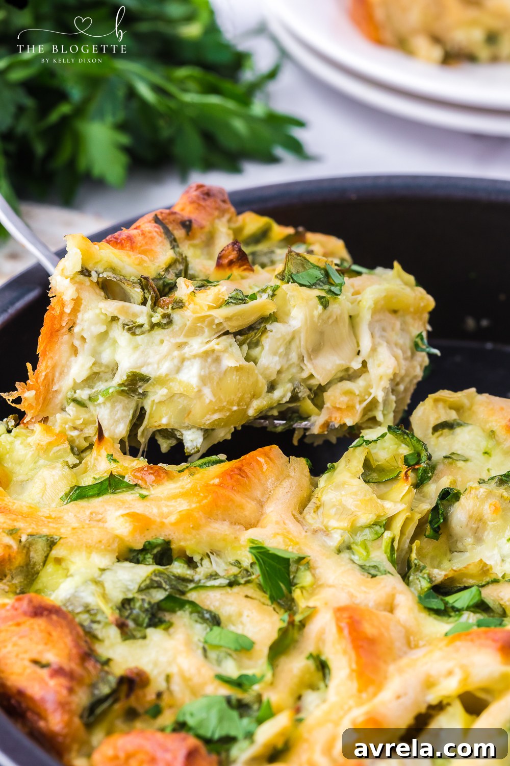 A close-up of baked Cheesy Spinach Artichoke Pinwheels, showcasing their golden crust and gooey cheesy filling.