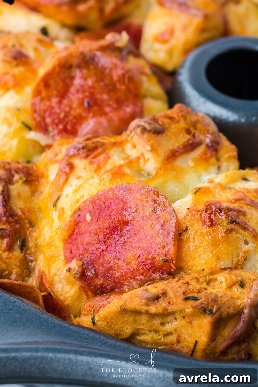 Cheesy Pizza Pull-Apart Bread 7 Bundt pan filled with unbaked Pull-Apart Pizza Bread mixture.