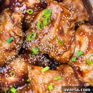 Crockpot Honey Garlic Chicken Recipe! Tender chicken thighs in a sweet and sticky sauce with a kick of heat.
