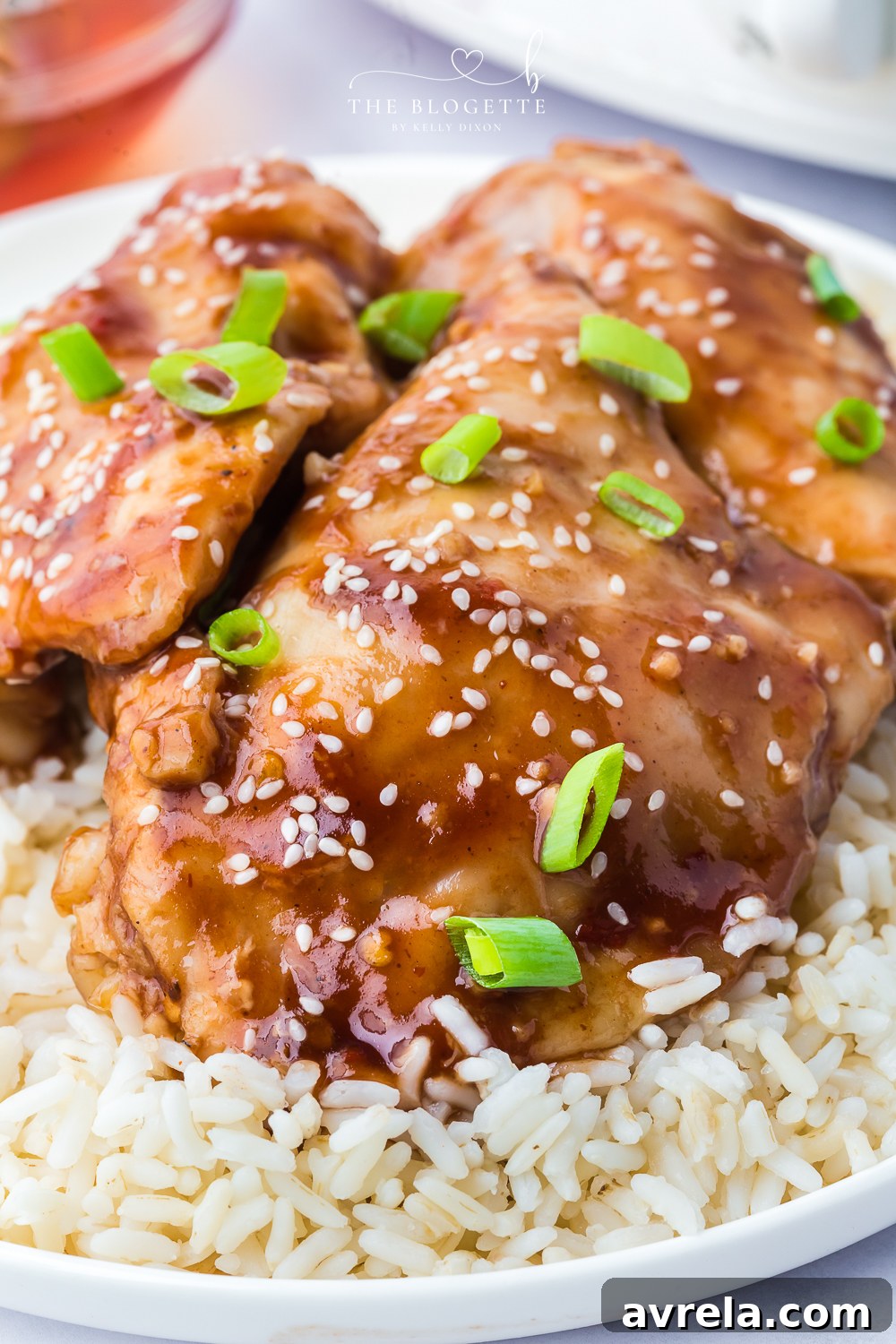 Crockpot Honey Garlic Chicken Recipe! Tender chicken thighs in a sweet and sticky sauce with a kick of heat.