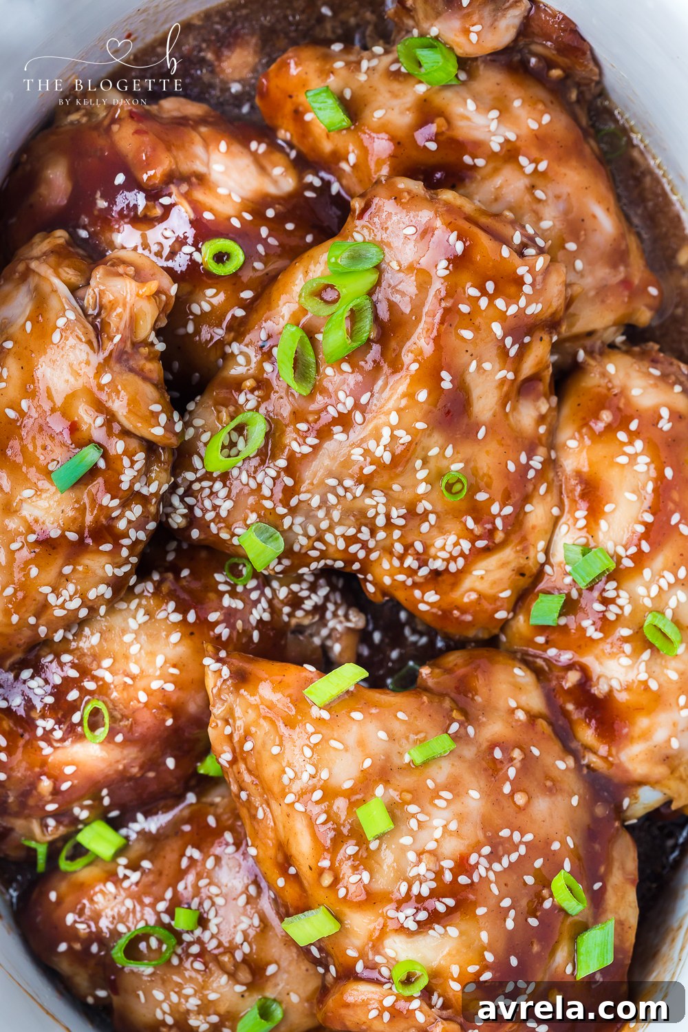 Crockpot Honey Garlic Chicken Recipe! Tender chicken thighs in a sweet and sticky sauce with a kick of heat.