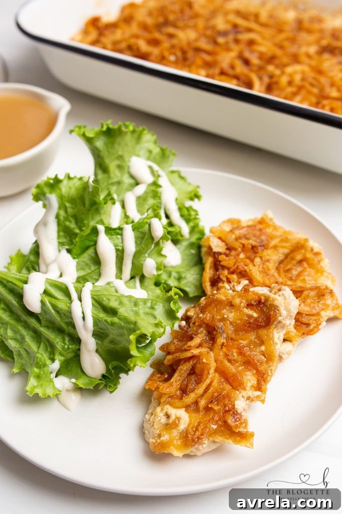 A close-up of a French Onion Pork Chop with creamy sauce and golden crispy onions, ready to eat.