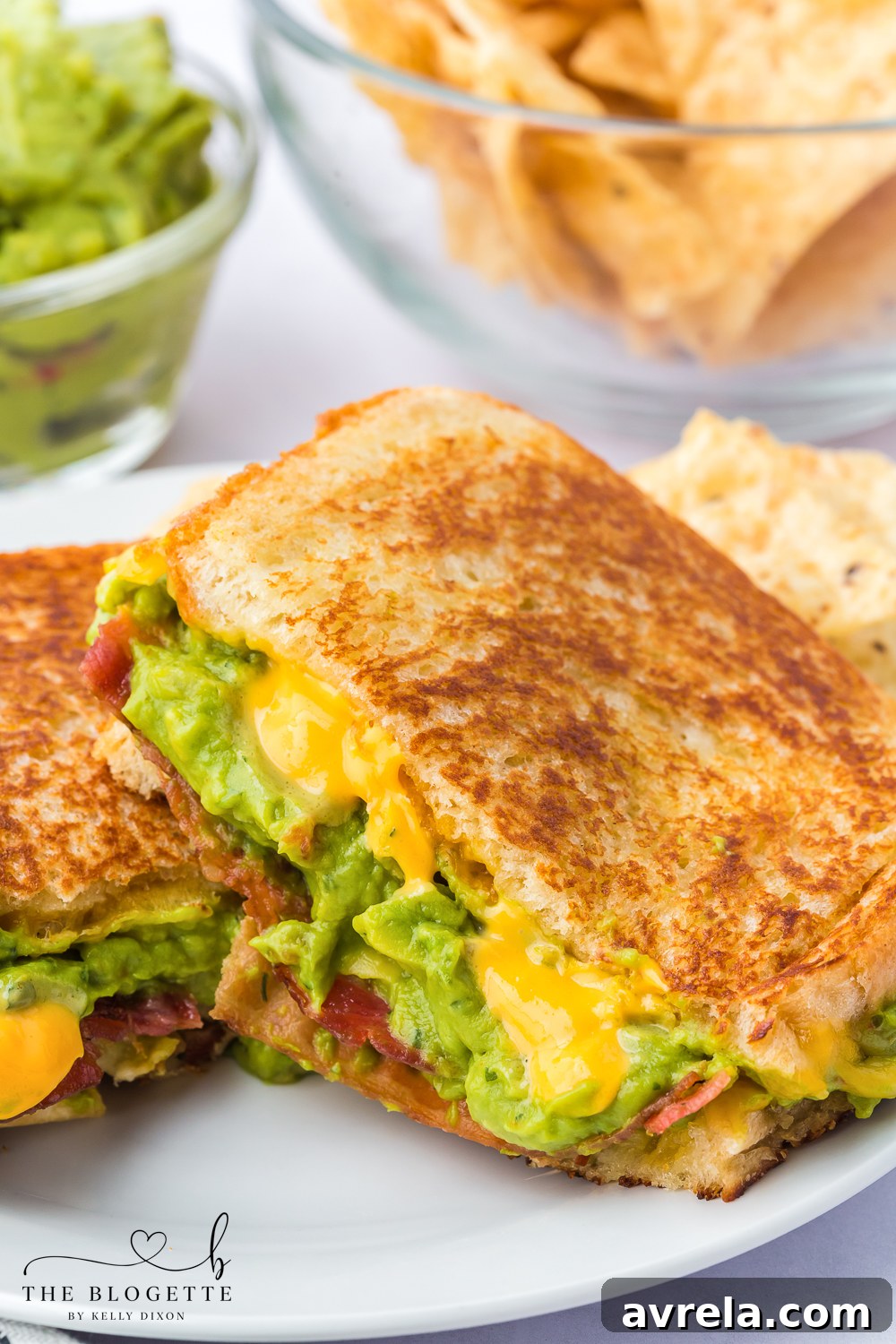 A cross-section view of a finished Bacon Guacamole Grilled Cheese Sandwich, showcasing all the delicious layers.