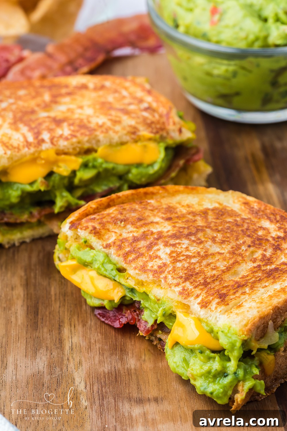Close-up of a Bacon Guacamole Grilled Cheese Sandwich, showing the layers of bacon, guacamole, and melted cheese.