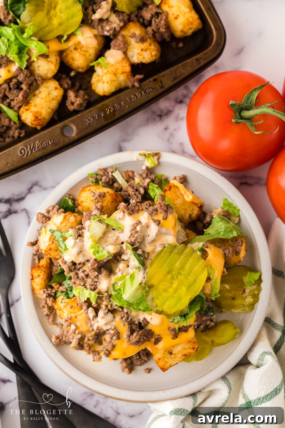 A vibrant close-up of Cheeseburger Totchos, showcasing crispy tater tots, savory ground beef, and perfectly melted cheese.