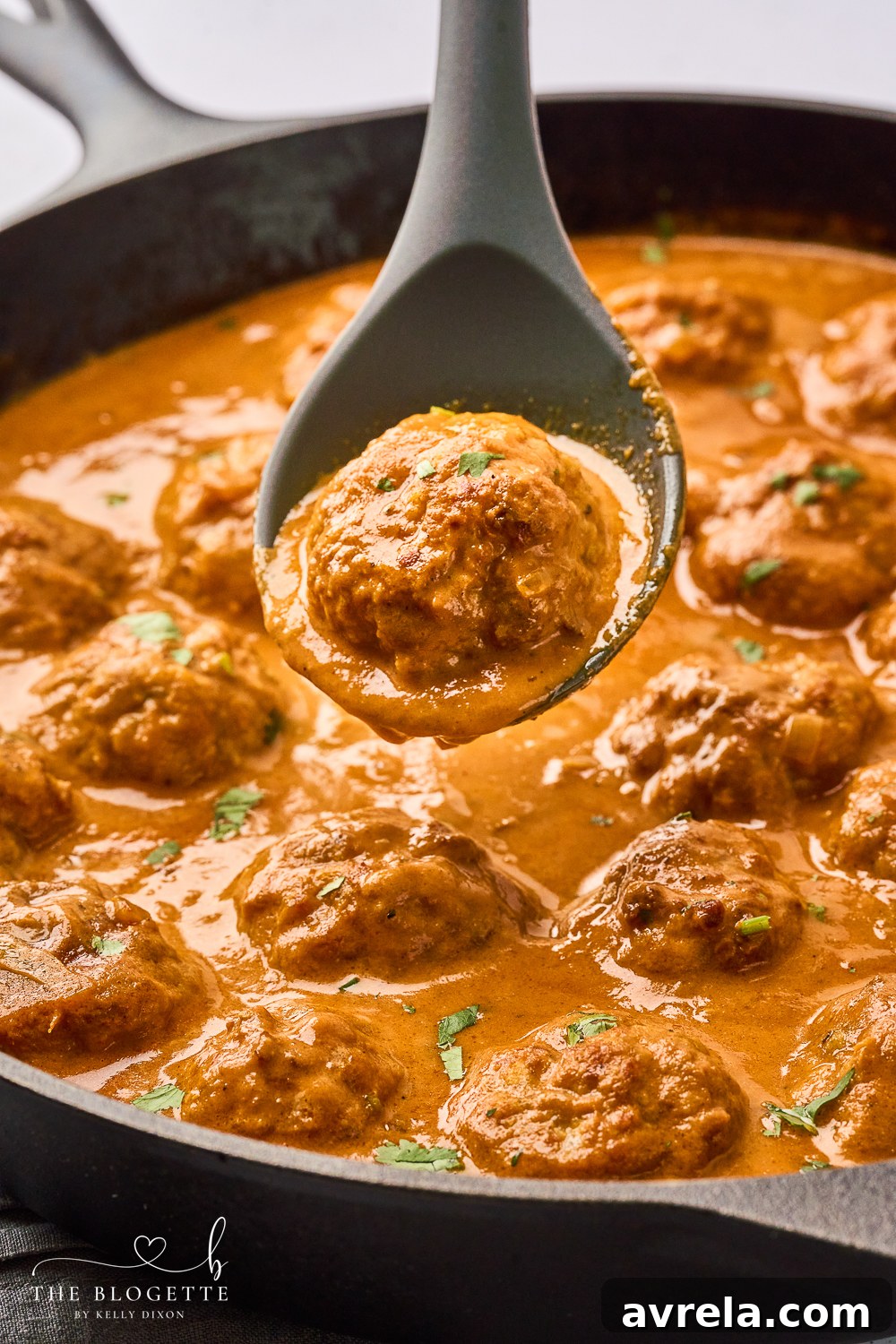 Velvety Makhani Sauce 11 A full plate of Butter Chicken Meatballs with rice and naan, ready to eat.