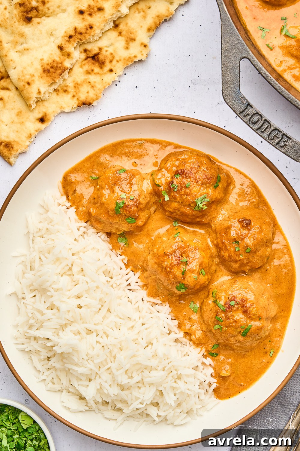 Velvety Makhani Sauce 12 A vibrant, creamy butter chicken sauce in a bowl, highlighted against a rustic background.
