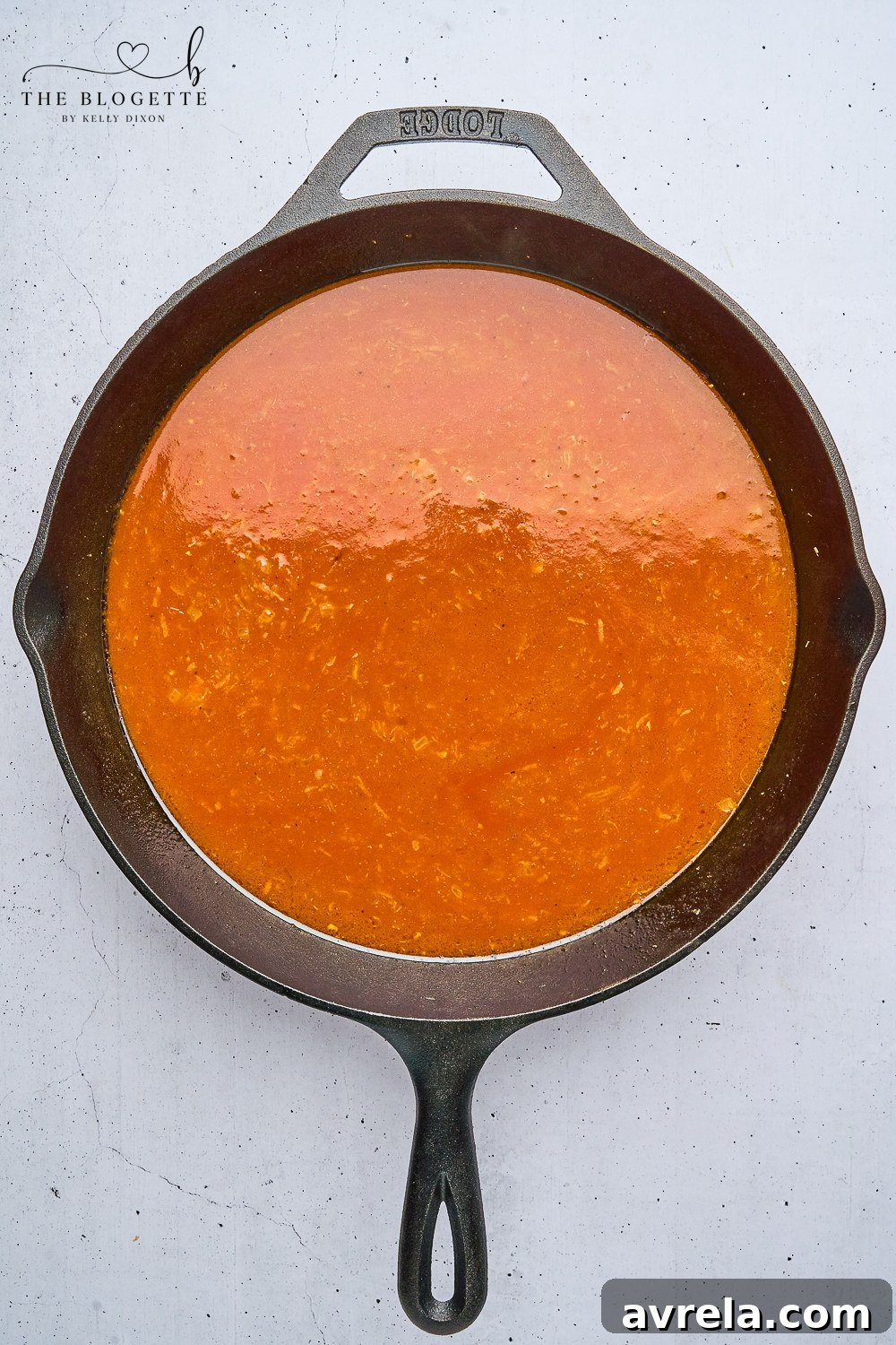 Velvety Makhani Sauce 8 Tomato sauce and paste added to the aromatic base in a skillet for butter chicken sauce.
