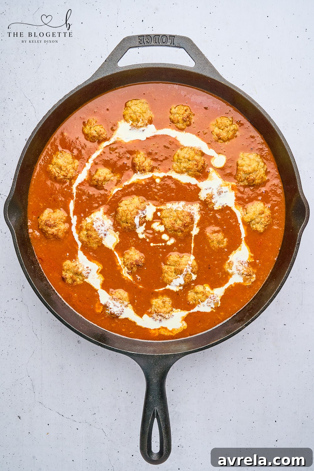Velvety Makhani Sauce 10 A close-up of the finished butter chicken sauce with meatballs, garnished for serving.