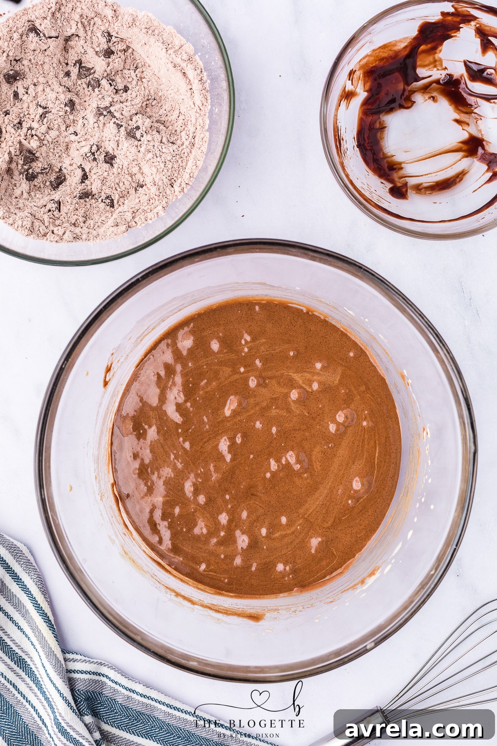 Brownie cookie dough with dry ingredients being folded in with a rubber spatula.