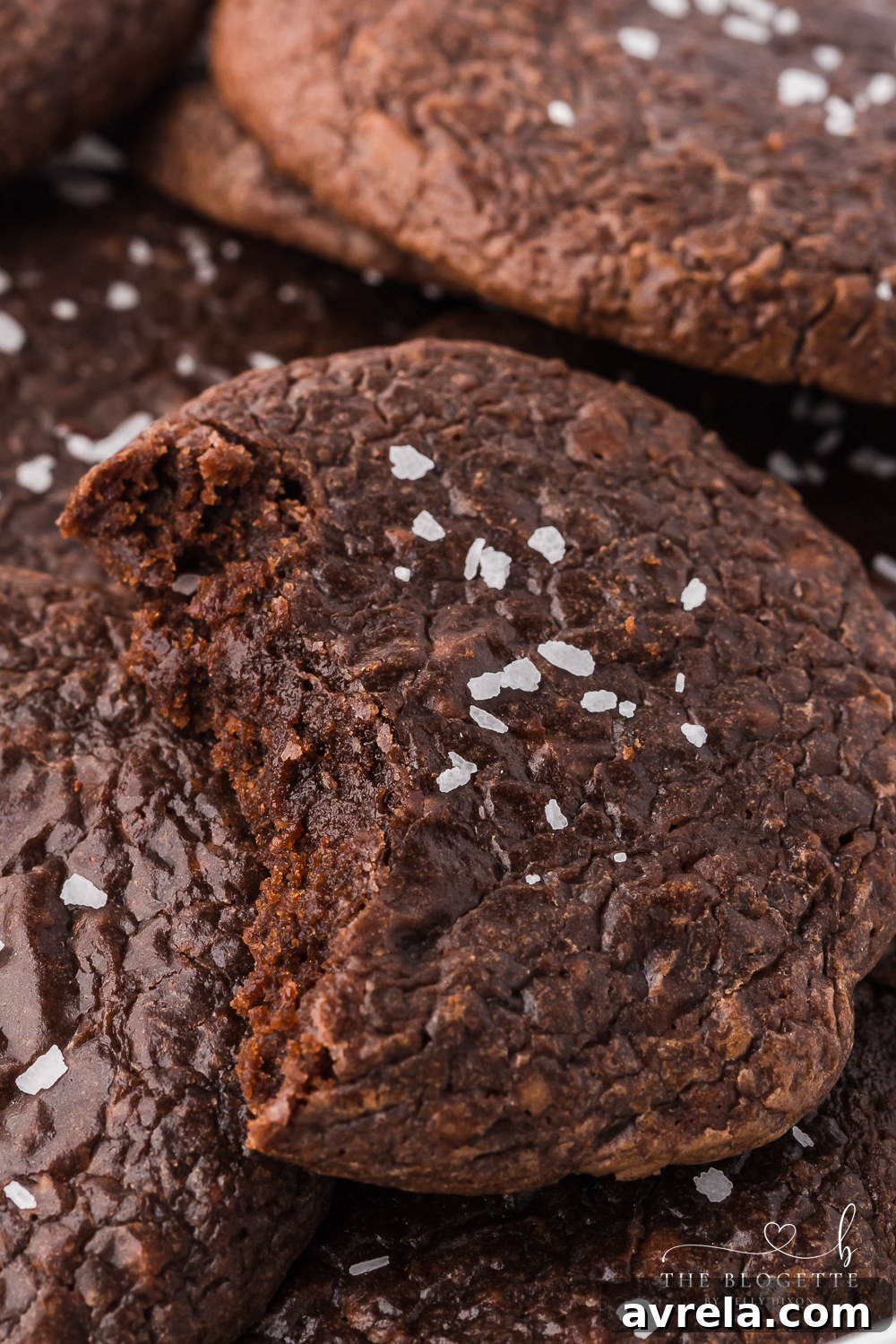 Stack of chocolate brownie cookies in an airtight container, ready for storage.