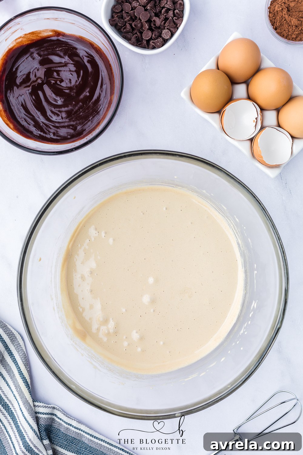 Close-up of pale, thick, and fluffy egg and sugar mixture after beating.