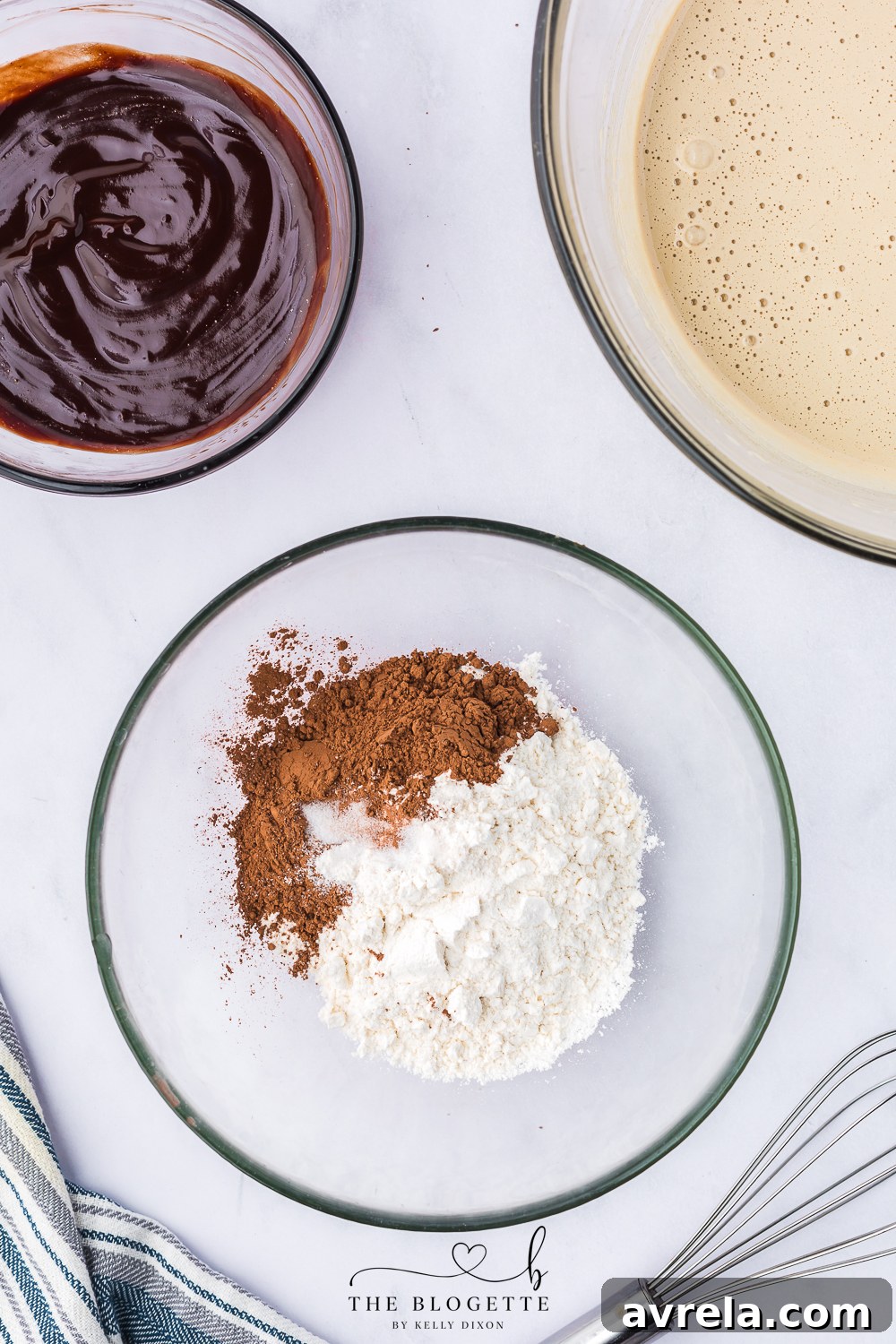 Sifting flour, cocoa powder, baking powder, and salt into a large mixing bowl.