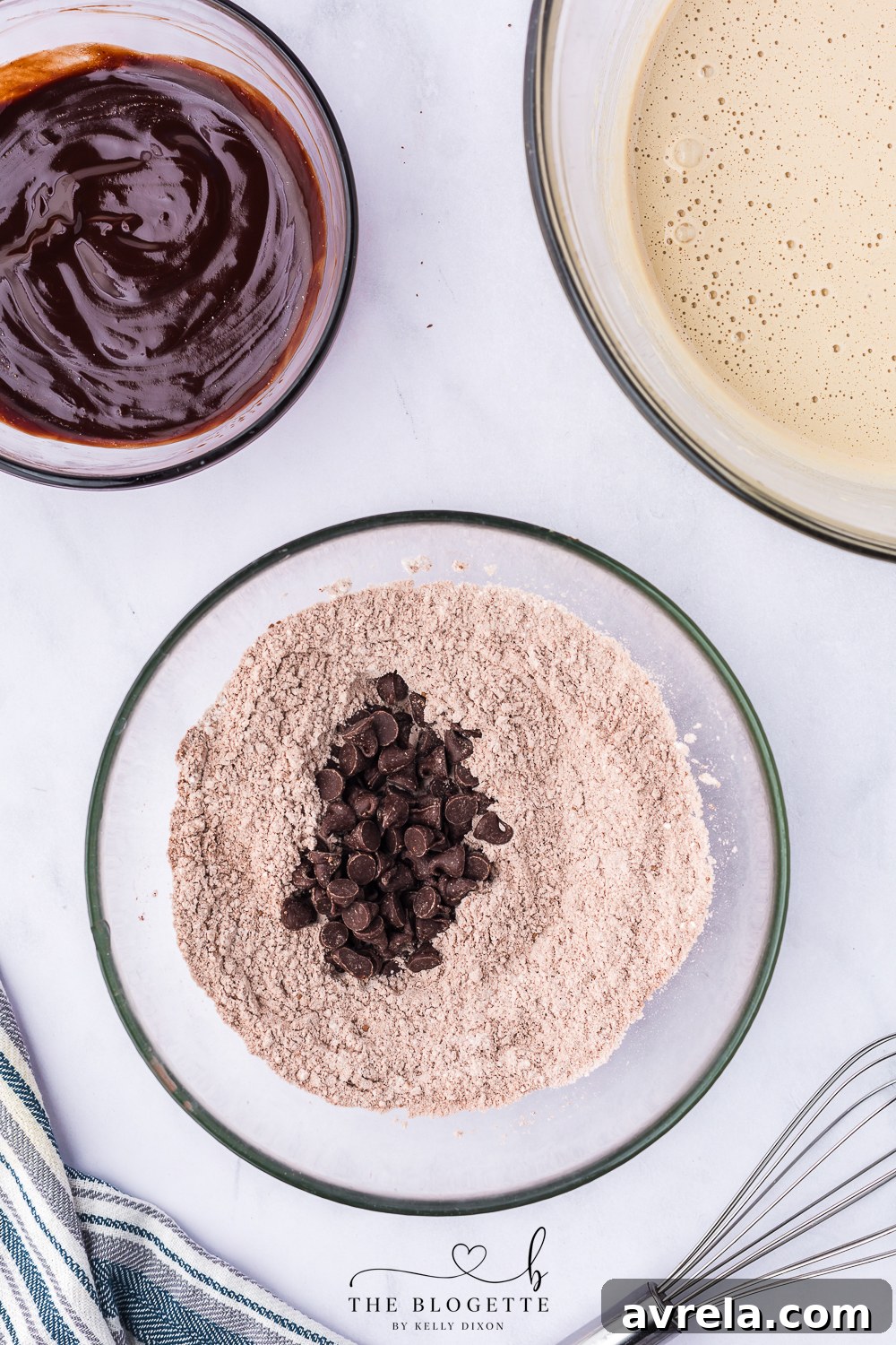 Chocolate chips being stirred into the sifted dry ingredients.